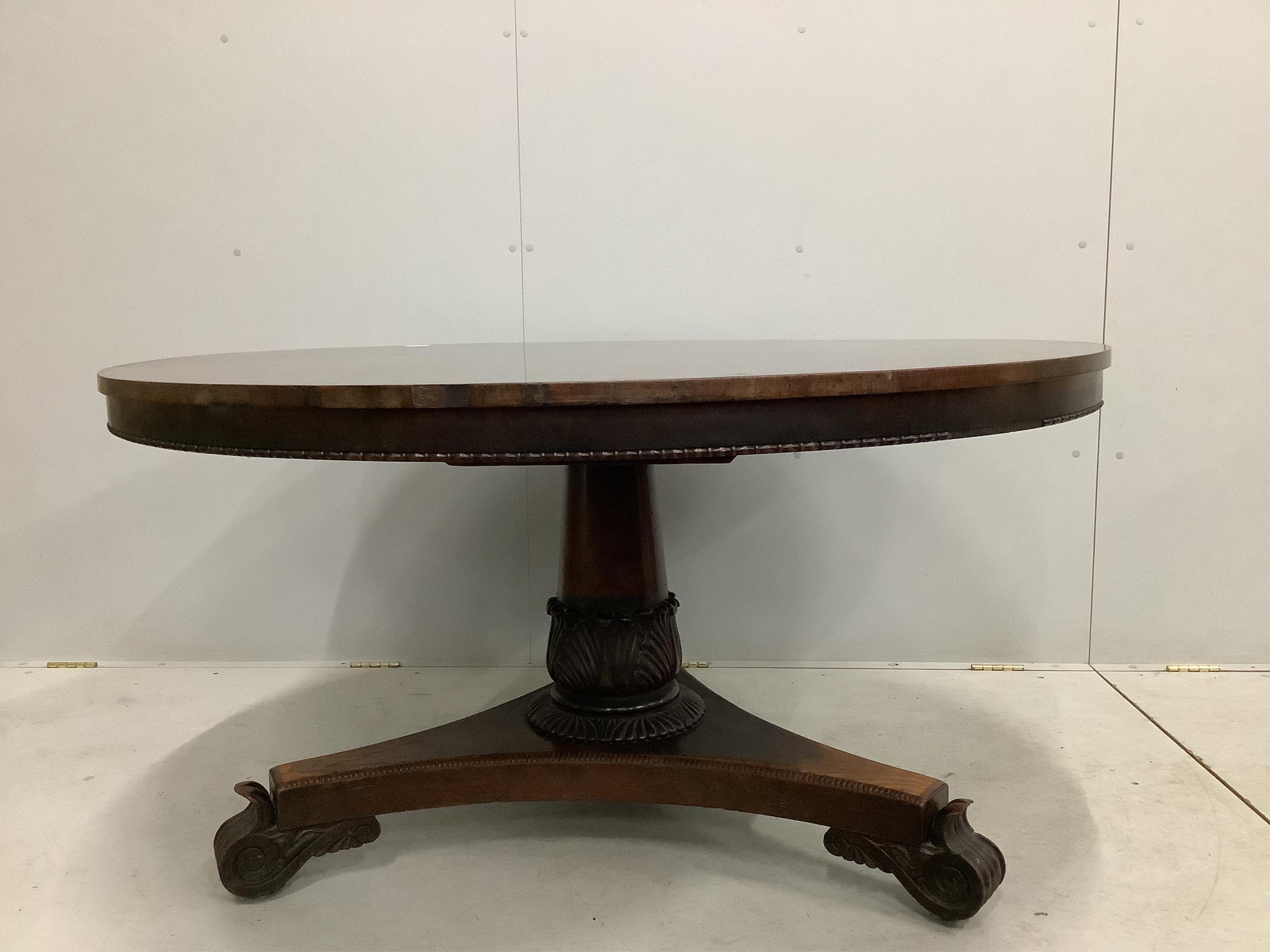 A Victorian rosewood circular tilt top breakfast table, diameter 135cm, height 72cm. Condition - poor to fair, triangular plinth base has lost approximately 10% of veneer